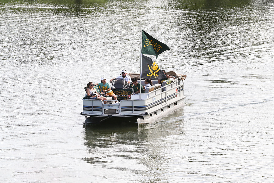 Baylor fans sailgating on the Brazos River